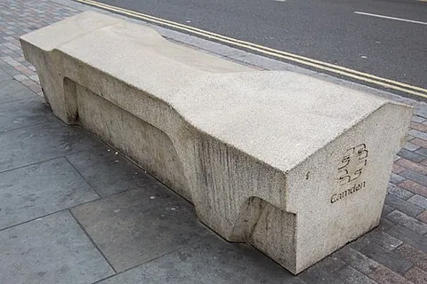 camden bench: a type of street furniture designed to restrict certain uses and behaviours and be usable only as a...