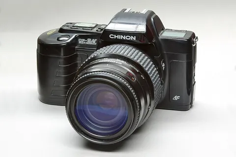 camera: a device for taking still or moving pictures or photographs
