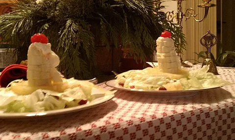 candle salad: a children's dish, composed of leaves of lettuce, pineapple rings, a banana, a cherry, mayonnaise,...