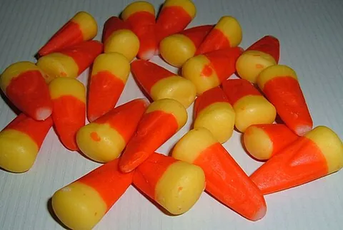 candy corn: a confection of sugar and corn syrup or honey, supposed to resemble a kernel of maize; typically...