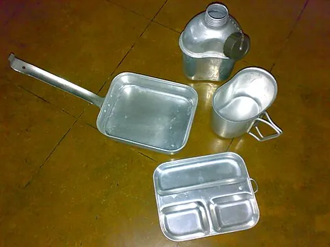 canteen cup: a metal cup which can be nested on the top or under a canteen