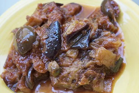 caponata: a Sicilian dish of baked aubergines with capers, olives, pine nuts etc, normally served cold