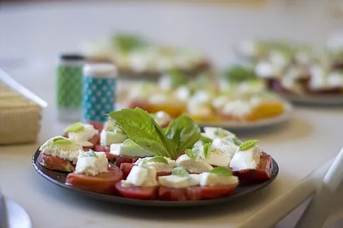 caprese salad: an Italian salad of sliced fresh mozzarella, tomatoes, and basil, seasoned with salt and olive oil