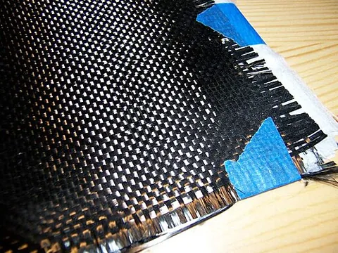 carbon fiber: a very strong filament made by the pyrolysis of a synthetic fiber such as rayon