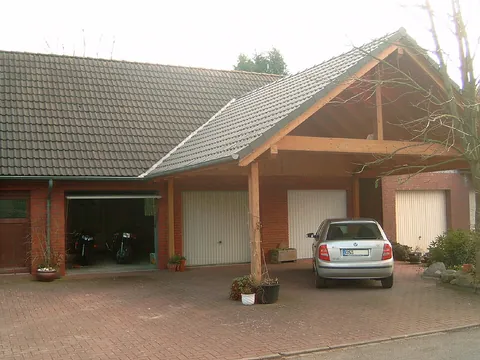 carport: a roofed structure for automobile storage, usually attached to a house and not fully enclosed like...