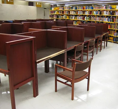 carrel: a partitioned space for reading or studying, often in a library