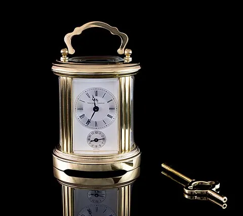 carriage clock: a small clock with a carrying handle, originally designed for travelling