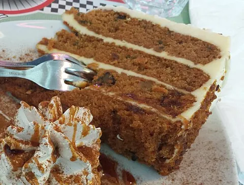 carrot cake: a sweet cake, often iced, containing grated carrot