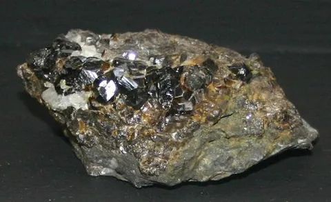 cassiterite: a generally black mineral, composed of tin oxide, SnO₂, which is an important ore of tin
