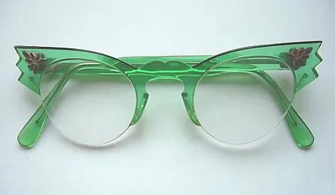 cat-eye: of glasses, having frames with an upward-slanting point at the top outer edges of the front