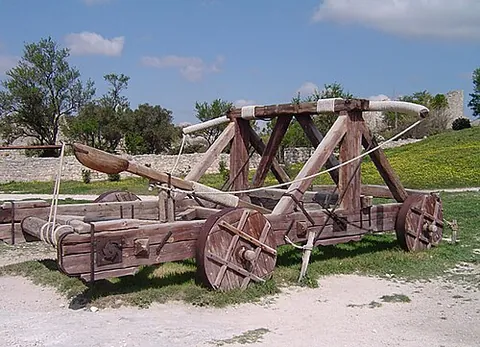 catapult: a device or weapon for throwing or launching large objects