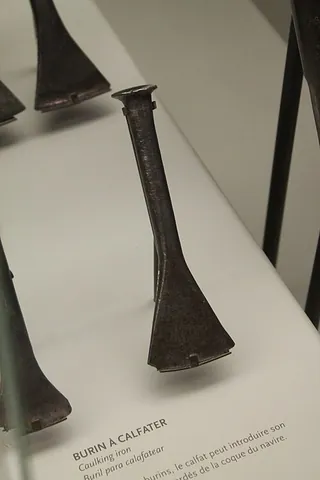 caulking iron: a tool, rather like a chisel, used to caulk a ship, tighten seams in ironwork and other things