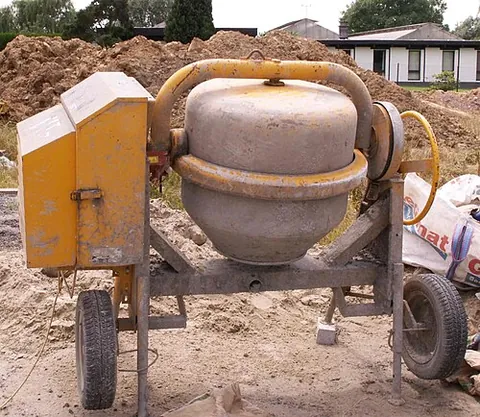 cement mixer: a device used in construction in which cement, aggregate and water are slowly mixed together in a...