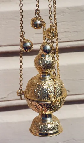 censer: an ornamental container for burning incense, especially during religious ceremonies