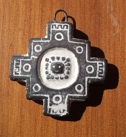 chakana: a stepped cross motif, often with a circle in the center, used by the Inca and other Andean cultures