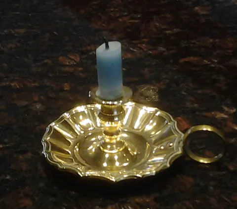 chamber candlestick: a small, portable candlestick suitable for carrying to the bedroom