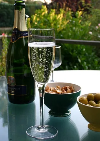 champagne flute: a piece of stemware with a long stem and a tall, narrow bowl on top, designed to keep champagne...