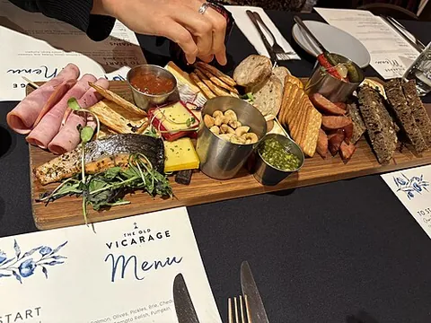 charcuterie board: a curated, visually appealing platter featuring arranged meats and cheeses, as well as crackers,...