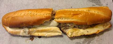 cheesesteak: a Philadelphia snack food consisting of chopped steak and melted cheese in a bread roll