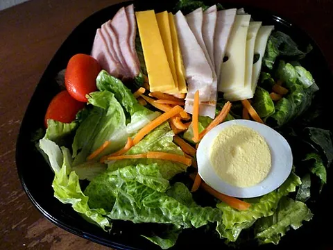 chef salad: a salad of hard-boiled eggs, meat, tomatoes, cucumbers, cheese (often shredded or crumbled), and...