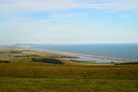 chesil beach: a long shingle beach or bank in Dorset, England, that stretches north-west from Portland towards...