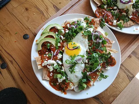 chilaquiles: a traditional Mexican dish of fried tortilla chips topped with salsa