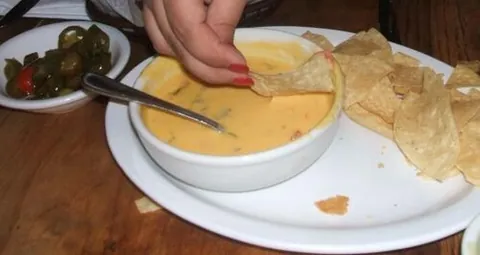 chile con queso: a creamy sauce used as a dip, made from melted cheese and chili peppers
