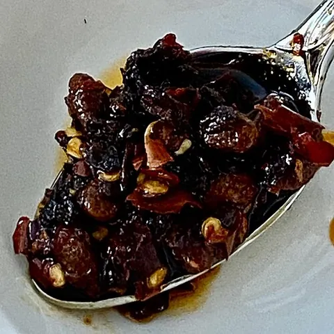 chili crisp: a Chinese hot sauce made with fried chili peppers infused in oil, sometimes with other ingredients