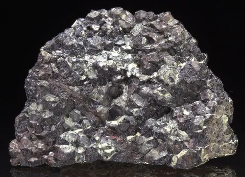 chromite: a dark brown mineral species with the formula FeCr₂O₄