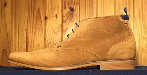 chukka boot: an ankle-high leather boot, typically suede, that has open lacing with two or three pairs of eyelets