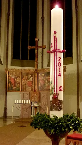 cierge: a wax candle used in religious rites