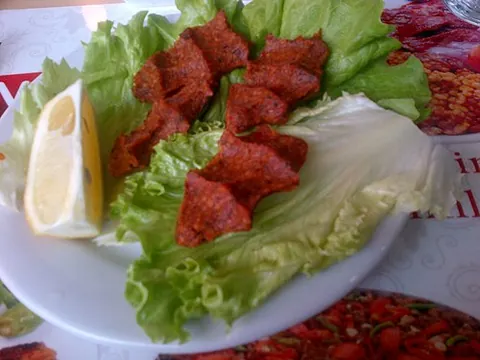 cig kofte: an Anatolian dish made from raw ground meat (often lamb or beef), bulgur, onion, tomato paste, hot...