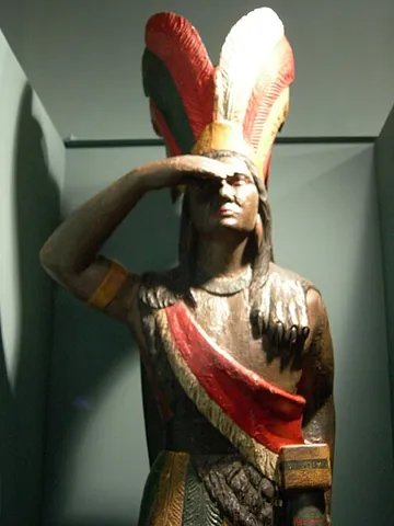 cigar store indian: a sculpture, typically wooden and painted, of a Native American Indian, of the sort prominently...