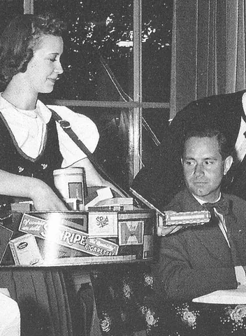 cigarette girl: a woman employed to sell cigarettes, sometimes cigars, and other related items