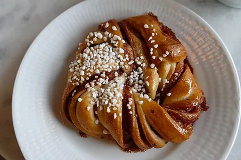 cinnamon roll: a rolled pastry flavored with cinnamon and sugar