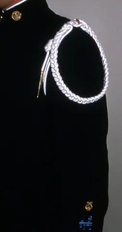 citation cord: a decorative cord worn on the shoulder, generally in conjunction with a uniform, also known as an...
