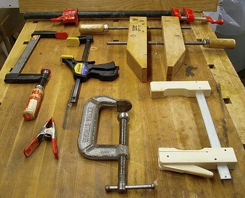 clamp: a brace, band, or clasp for strengthening or holding things that are apart together