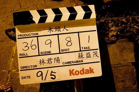 clapperboard: a device consisting of a board on which information about a film being recorded is noted, and a...