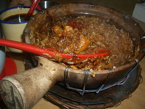 claypot rice: a traditional Chinese rice casserole with meat and vegetables, developing a scorched crust of rice...