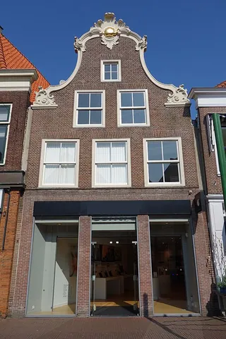 clock gable: a gable or facade with a decorative bell-shape, characteristic of traditional Dutch architecture