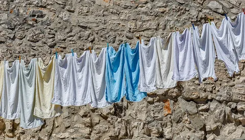 clothesline: a rope or cord tied up outdoors to hang clothes on so they can dry