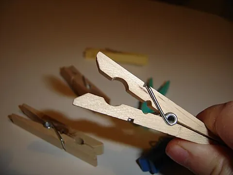 clothespin: a clip or fastener used to secure garments to a clothesline while drying, and sometimes for other...