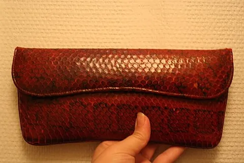 clutch bag: a small handbag without a shoulder strap, designed to be held in the hand