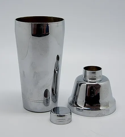cocktail shaker: a device used to mix beverages (usually alcoholic) by shaking