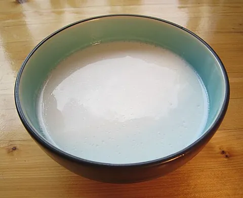 coconut milk: a thick white liquid produced by soaking the white inner flesh of the seed of the coconut in water...