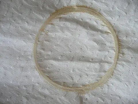 coffee ring: a brown ring-shaped stain left on a surface after a cup of coffee has been placed on it