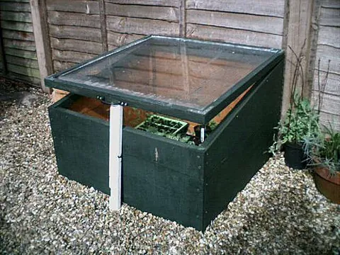 cold frame: a transparent-roofed enclosure, built low to the ground, used to protect plants from cold weather