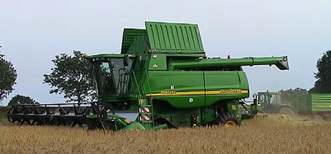 combine harvester: a farm machine that harvests, threshes, and winnows ripe grain