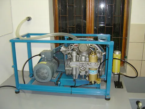 compressor: a device that produces pressure, such as a gas compressor that produces pressurized gas