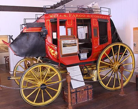 concord coach: a kind of American horse-drawn coach, often used as a stagecoach or mailcoach, having easily...